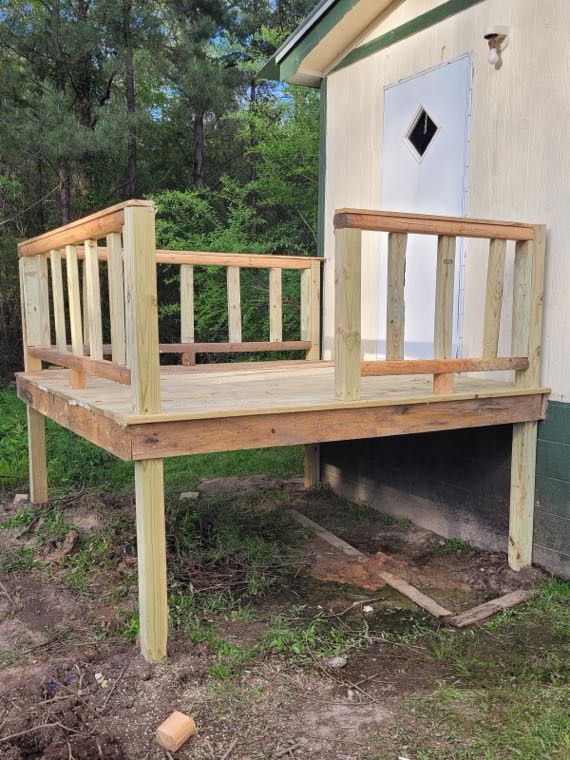 Finished raised deck with a new pressure-treated wood railing